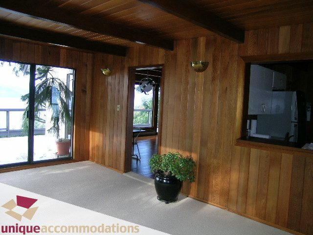 Bright kitchen with wood paneling and countertop, featuring a city view. - 310 Bayview Road, West Vancouver