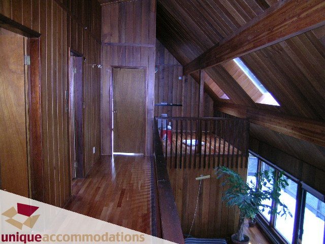 Furnished attic space with wooden beams and hardwood floors. - 310 Bayview Road, West Vancouver
