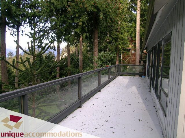 Furnished balcony with glass railings and forest view. - 310 Bayview Road, West Vancouver