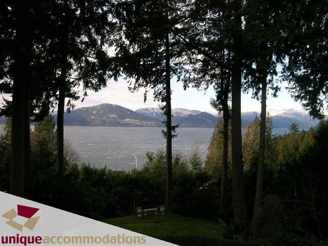 Furnished living room with a stunning mountain and water view. - 310 Bayview Road, West Vancouver