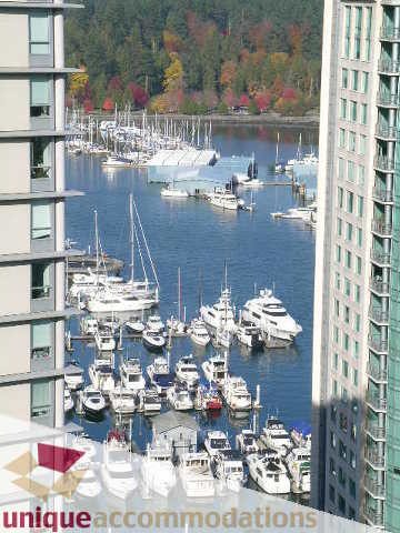 Bright living room with stunning city view and marina, surrounded by colorful autumn foliage. - 2801 - 1205 W. Hastings Street, Vancouver Downtown