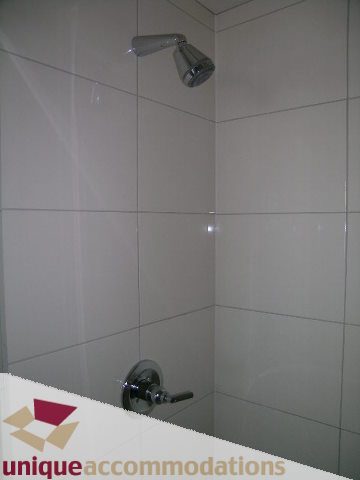 Bathroom with white tiles and modern showerhead. - 2801 - 1205 W. Hastings Street, Vancouver Downtown
