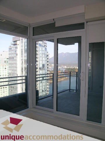 Spacious living room with large windows offering a stunning city view. - 2801 - 1205 W. Hastings Street, Vancouver Downtown