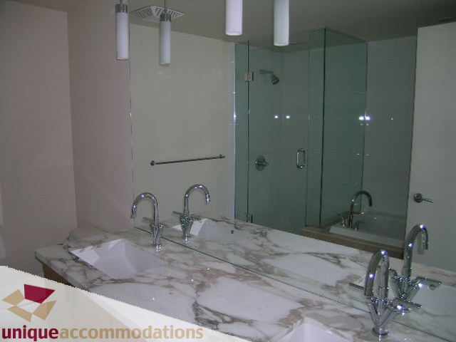 Bathroom with marble countertop and glass shower, modern fixtures. - 2801 - 1205 W. Hastings Street, Vancouver Downtown