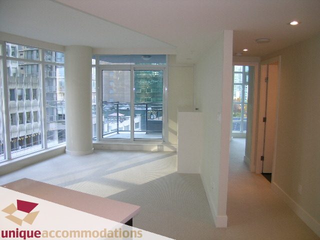 Bright open-concept living room with large windows and city view. - 705 - 1205 W Hastings, Vancouver Downtown