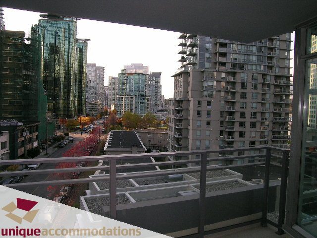 Furnished 1-bedroom balcony with city view and modern furnishings. - 705 - 1205 W Hastings, Vancouver Downtown