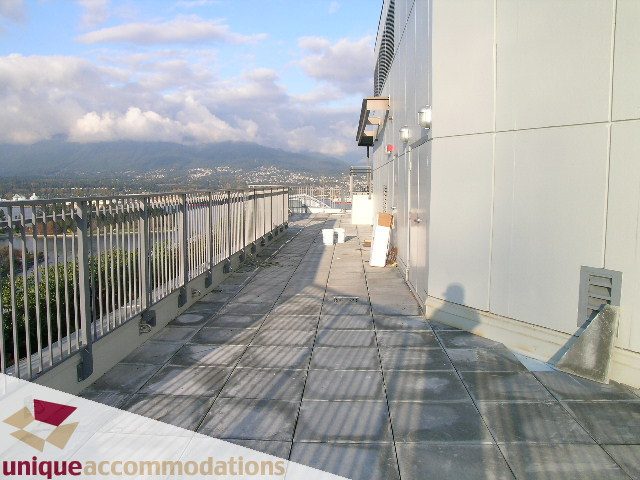 Furnished balcony with city view and modern railings. - 705 - 1205 W Hastings, Vancouver Downtown