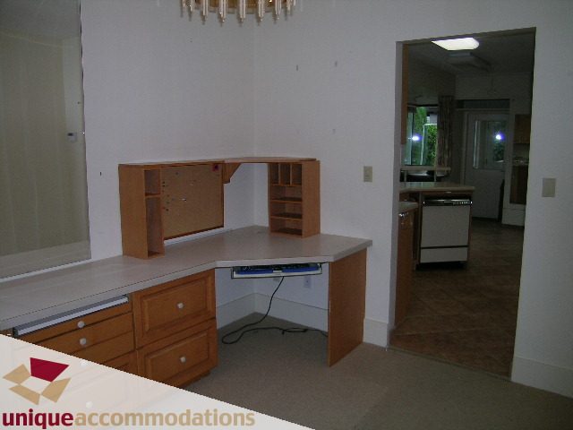 Furnished kitchen with light wood cabinets and countertop, leading to a den area. - 782 W 22nd Ave, Vancouver West Side
