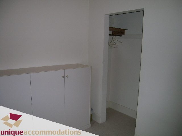Small closet with hangers and shelves, white walls, minimal decor. - 782 W 22nd Ave, Vancouver West Side