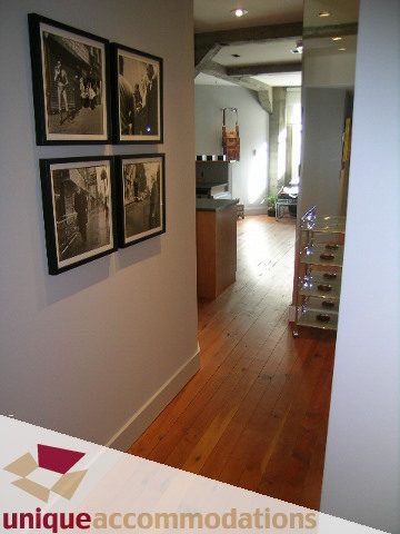 Bright kitchen with hardwood floors and framed black-and-white photos on the wall. - 211- 1216 Homer, Vancouver Downtown