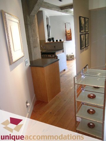 Bright kitchen with wooden floors, glass shelves, and a cozy corner nook. - 211- 1216 Homer, Vancouver Downtown