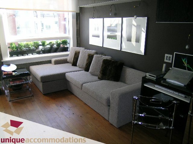 Furnished living room with hardwood floors, city view, and modern decor. - 211- 1216 Homer, Vancouver Downtown