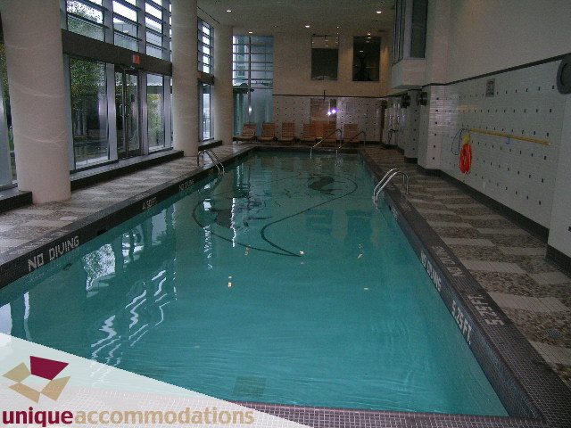 Spacious, modern indoor pool with tiled walls and floor, natural light from large windows. - 506 - 590 Nicola Street, Vancouver Downtown