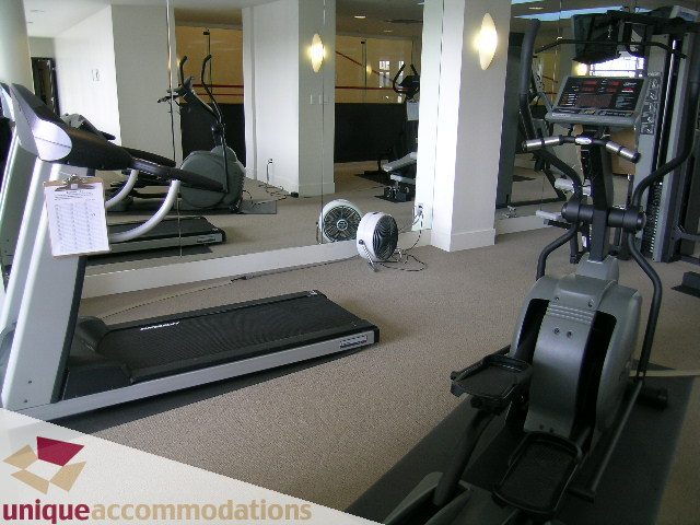 Furnished fitness room with cardio equipment and mirrors. - 3301-1495 Richards, Vancouver Downtown