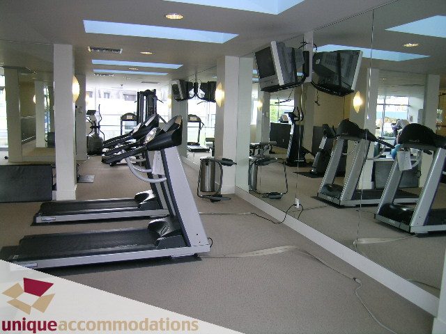 Fitness room with treadmills and mirrors, spacious and well-lit. - 3301-1495 Richards, Vancouver Downtown
