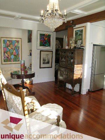 Furnished living room with hardwood floors, chandelier, and artwork. - 47-777 Burrard Street, Vancouver Downtown