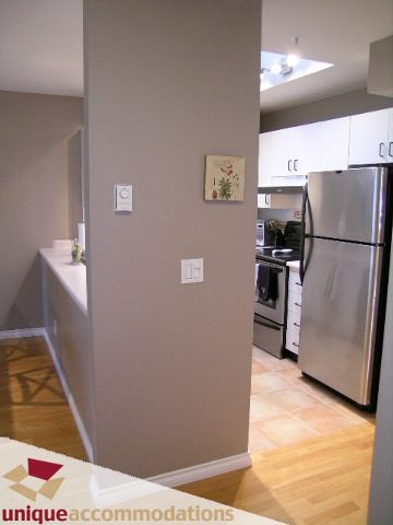 Bright kitchen with white countertops, hardwood floors, and stainless steel appliances. - 408-2250 West 3rd Avenue, Vancouver West Side
