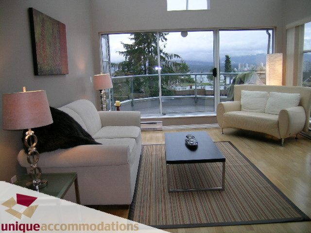 Furnished living room with hardwood floors, city view, and modern decor. - 408-2250 West 3rd Avenue, Vancouver West Side