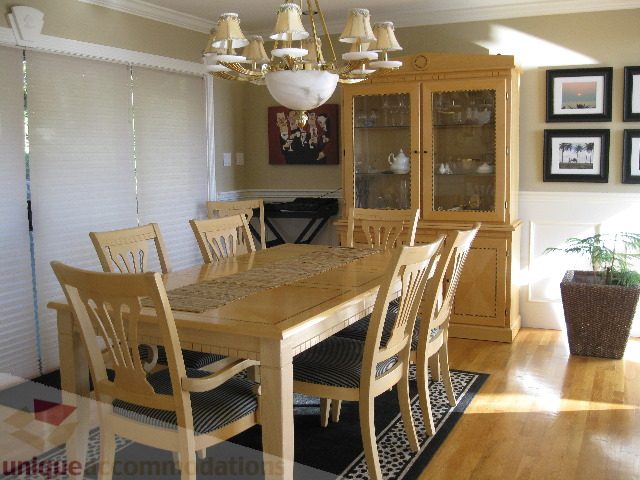 Furnished dining room with wooden table, chairs, and glass cabinet. - 4139 Quarry Court, North Vancouver