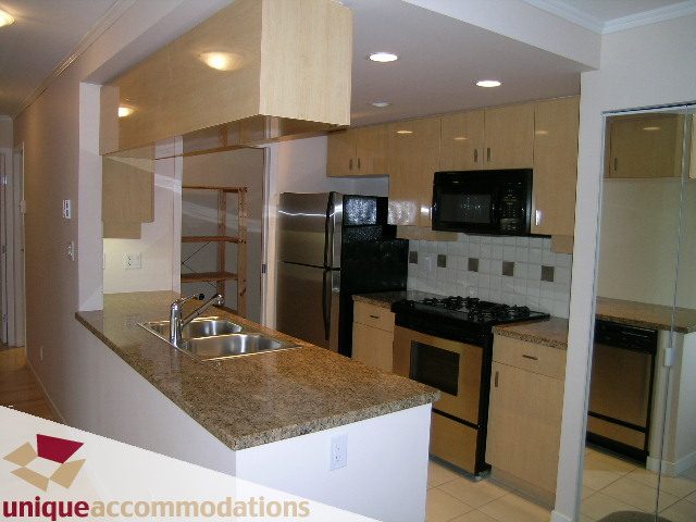 Bright kitchen with granite countertops and stainless steel appliances. - 2908 - 1033 Marinaside Crescent, Vancouver Downtown