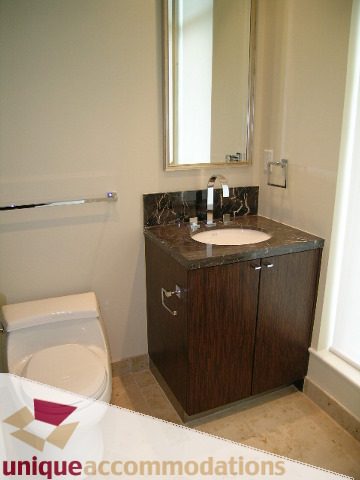 Modern bathroom with dark wood cabinets and marble countertops. - PH1 - 508 Waters Edge Cres., West Vancouver