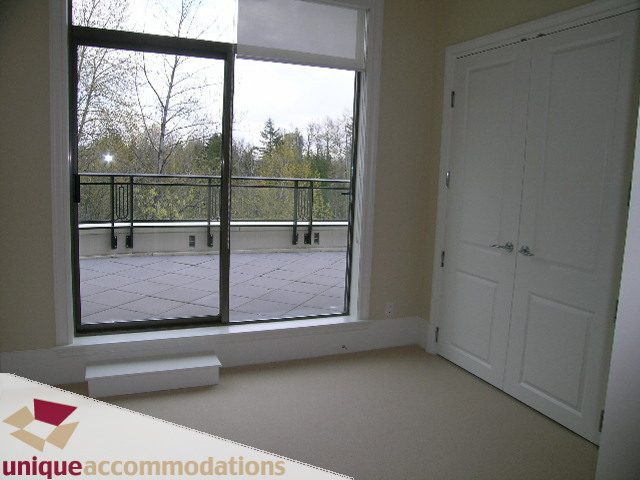 Bright living room with large windows and city view, white cabinetry. - PH1 - 508 Waters Edge Cres., West Vancouver