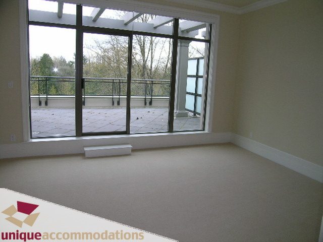 Spacious living room with large windows and a view of the balcony. - PH1 - 508 Waters Edge Cres., West Vancouver