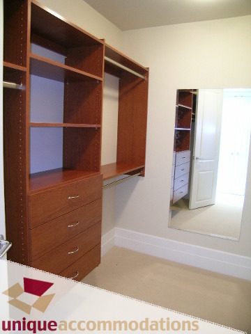 Spacious walk-in closet with ample shelves and drawers, light wood finish. - PH1 - 508 Waters Edge Cres., West Vancouver