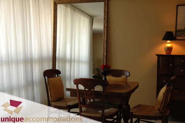 Bright living room with large mirror, wooden furniture, and soft lighting. - 2314 - 938 Smithe Street, Vancouver Downtown