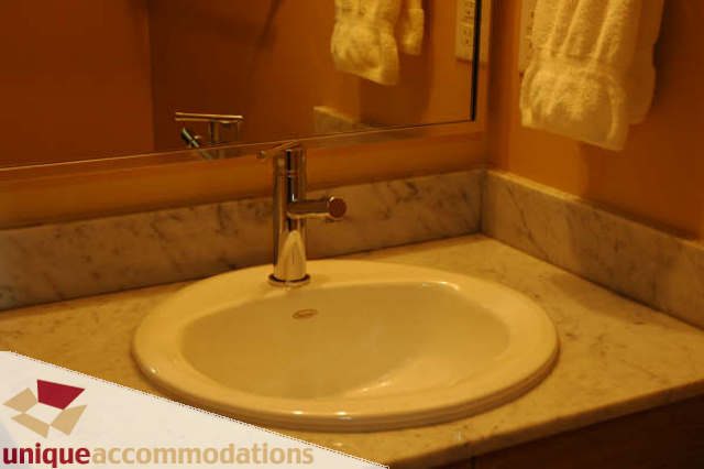 Bathroom with marble countertop and modern sink fixtures. - 2314 - 938 Smithe Street, Vancouver Downtown