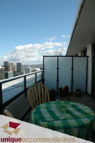 Furnished balcony with city view and outdoor dining table. - 2314 - 938 Smithe Street, Vancouver Downtown