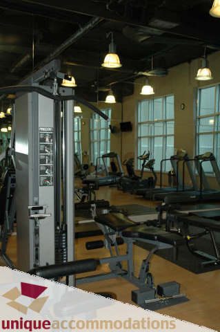 Well-lit gym with treadmills, weight machines, and large windows. - 2314 - 938 Smithe Street, Vancouver Downtown