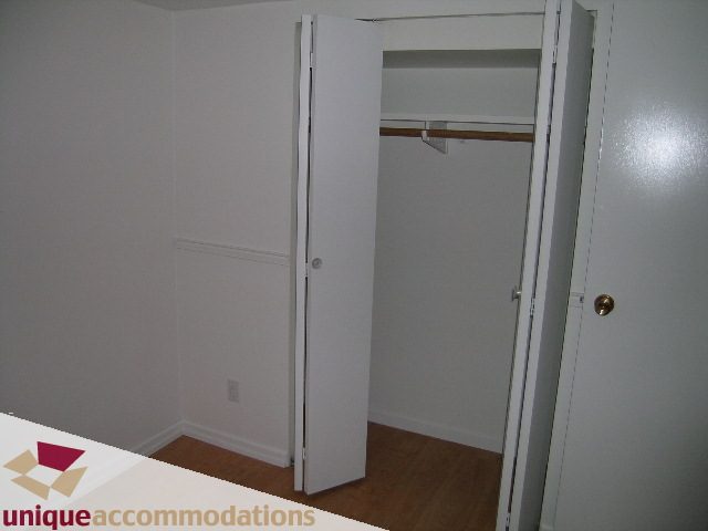 Bright bedroom with open closet and hardwood floors. - 1428 29th Street, West Vancouver