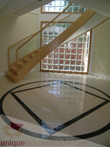 Stunning entryway with glass block wall and modern staircase. - 4215 Evergreen Ave, West Vancouver