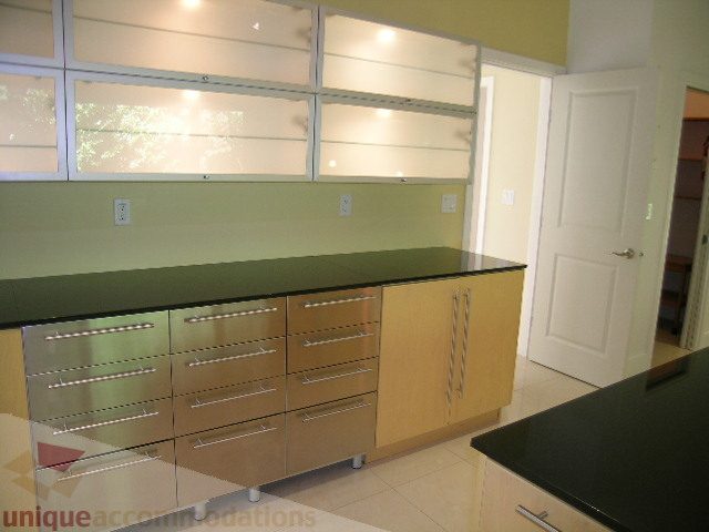 Bright kitchen with stainless steel appliances and light wood cabinets. - 4215 Evergreen Ave, West Vancouver
