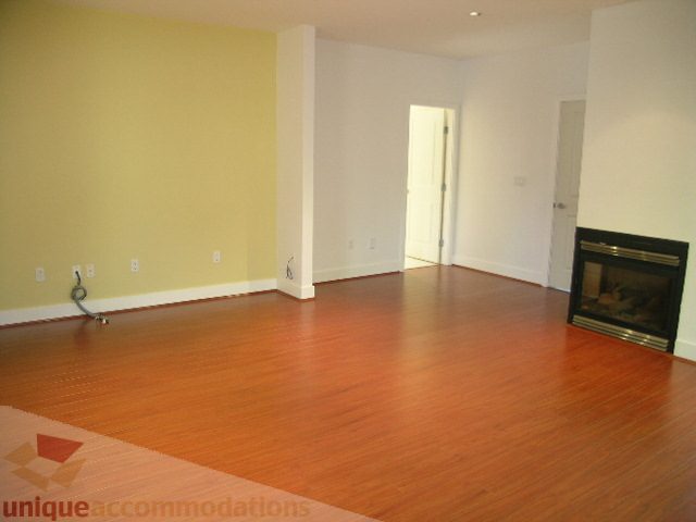 Living room with hardwood floors and a fireplace. - 4215 Evergreen Ave, West Vancouver
