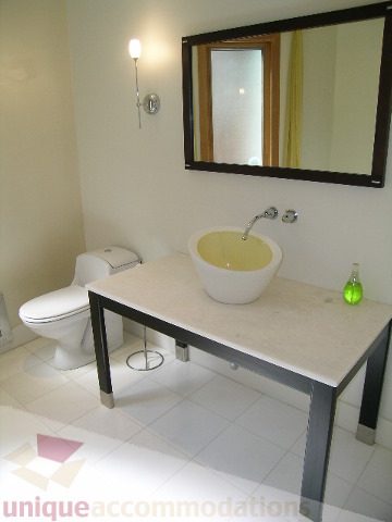 Bathroom with white countertops and modern sink. - 4215 Evergreen Ave, West Vancouver