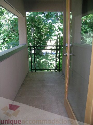 Spacious balcony with glass railings and lush greenery view. - 4215 Evergreen Ave, West Vancouver
