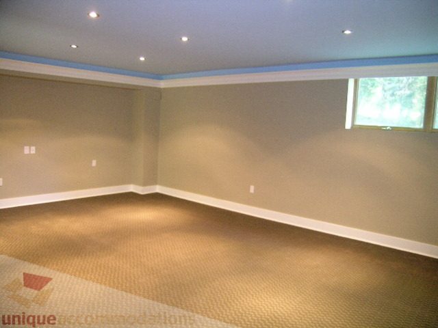 Spacious living room with carpeted floor and large window. - 4215 Evergreen Ave, West Vancouver