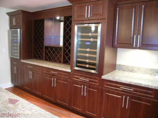 Bright kitchen with granite countertops, dark wood cabinets, and stainless steel appliances. - 4215 Evergreen Ave, West Vancouver