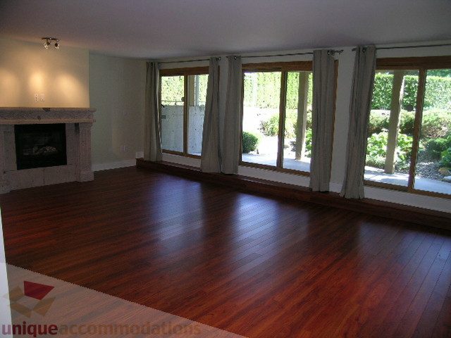 Spacious living room with hardwood floors and large windows. - 4215 Evergreen Ave, West Vancouver