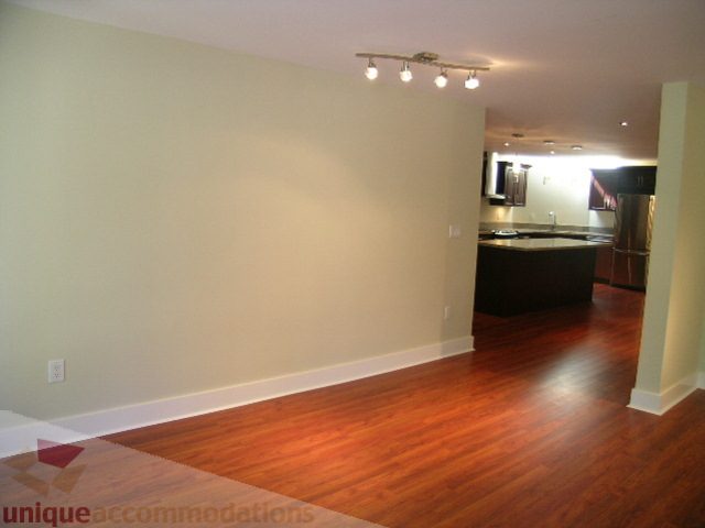 Spacious living room with hardwood floors and modern lighting. - 4215 Evergreen Ave, West Vancouver