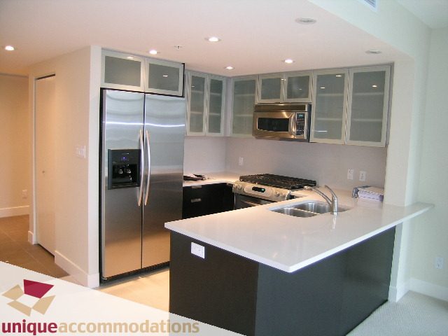 Bright kitchen with white countertops and stainless steel appliances, modern design. - 1805 -1205 W Hastings, Vancouver Downtown