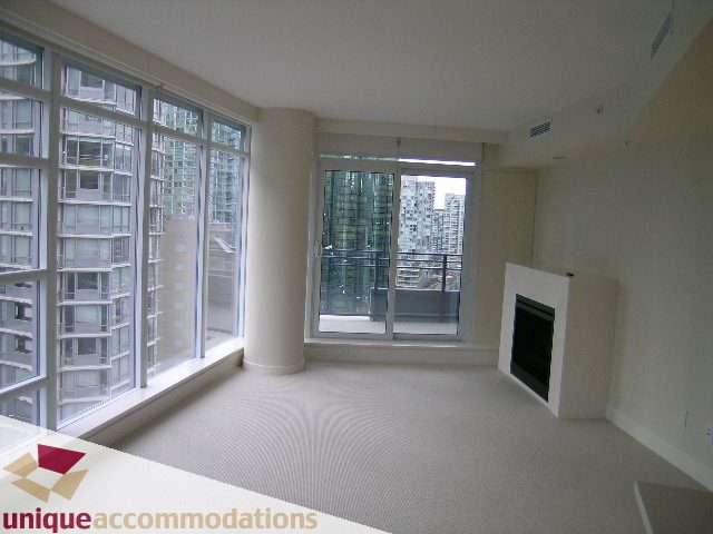 Bright living room with large windows and city view, modern furnishings. - 1805 -1205 W Hastings, Vancouver Downtown