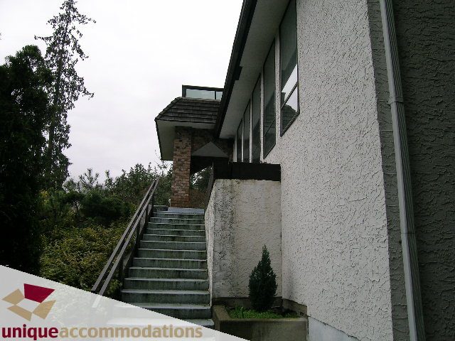 Furnished 5-bedroom house with concrete steps and modern exterior. - 5568 Greenleaf Road, West Vancouver