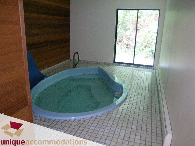 Jacuzzi with tiled floor and large window view. - 5568 Greenleaf Road, West Vancouver