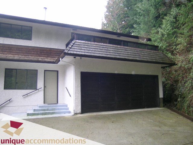 Bright 5-bedroom house with modern design, large windows, and a spacious driveway. - 5568 Greenleaf Road, West Vancouver