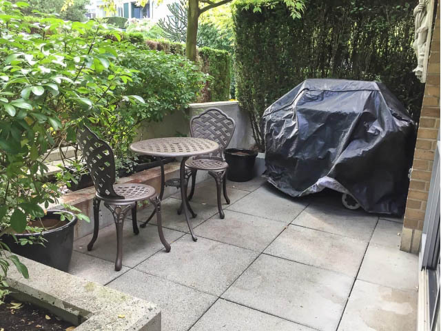 Outdoor patio with wrought iron table and lush greenery for al fresco dining. - 2H - 1067 Marinaside Crescent, Vancouver Downtown