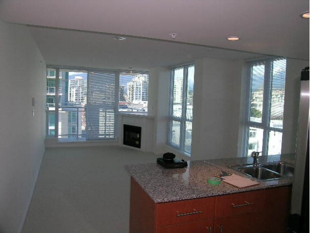 Bright kitchen with granite countertops and city view, perfect for a cozy stay. - 1008 - 188 East Esplanade, North Vancouver