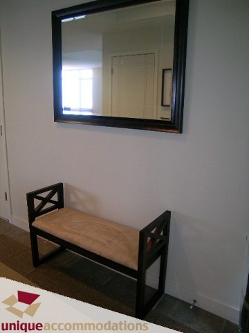 Furnished entryway with wooden bench and large mirror reflecting natural light. - 8583 Seascape Lane, West Vancouver